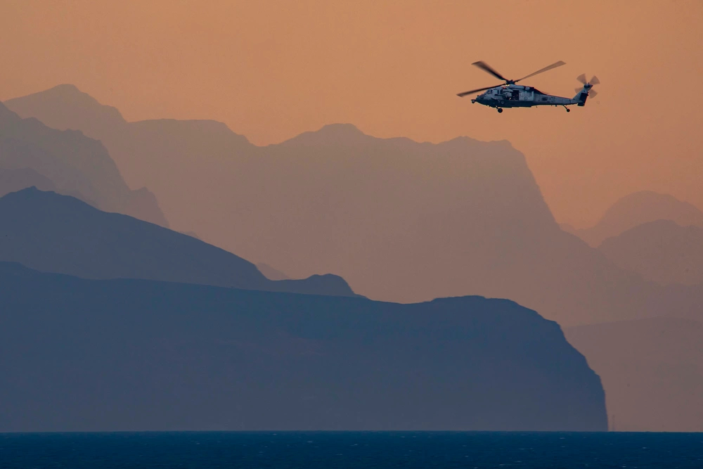 A US Navy MH-60 Helicopter patrols the Strait of Hormuz